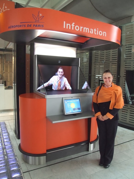 Visitor speaking face-to-face with a remote receptionist through a video reception screen